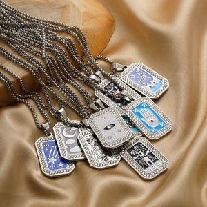 Macro shot of tarot pendants with enamel celestial patterns on silk background