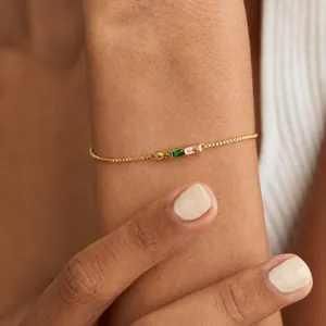 Detail of 18K gold-plated box chain bracelet with three rectangular colorful stones