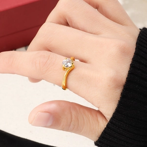Detailed view of an 18K gold V-shaped bypass ring with a brilliant round zircon stone