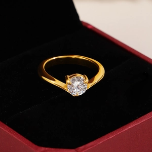 Close-up of a V-shaped gold ring with a 1-carat zircon in a luxury jewelry box