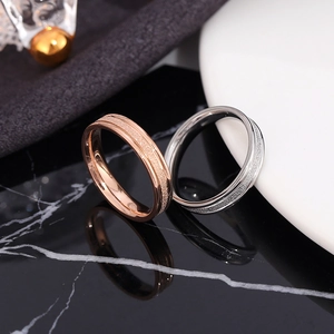 Minimalist matte stainless steel rings in rose gold and silver finishes with polished edges
