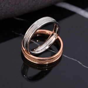 Sleek silver and rose gold stainless steel couple rings with frosted sand texture
