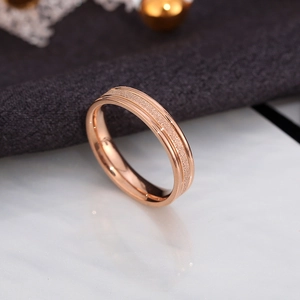 Detailed close-up of rose gold stainless steel ring with frosted and polished finishes