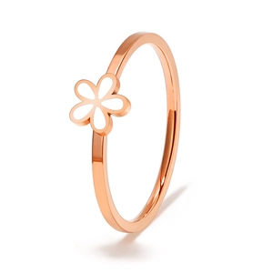Detailed macro of rose gold titanium ring with a delicate white enamel daisy flower