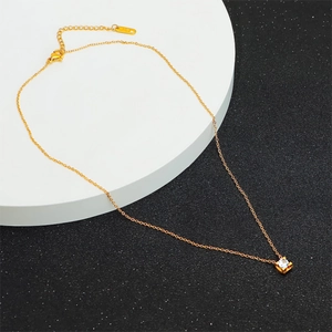 18k rose gold plated necklace with a single sparkling cubic zirconia pendant on white stand