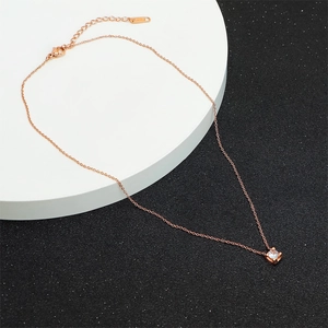 Detailed lobster clasp and adjustable chain on a rose gold single zircon necklace