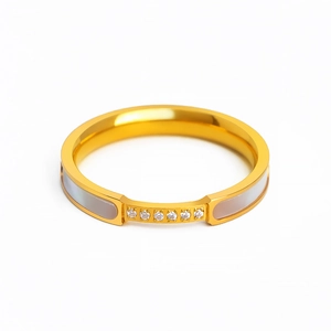 Polished gold titanium steel ring featuring inlaid white shell and six brilliant cubic zircons