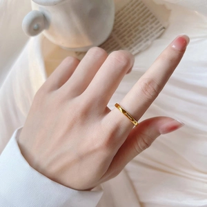 Minimalist gold titanium steel ring with Je t'aime engraving worn on index finger