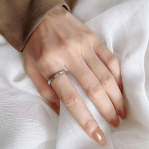 Engraved stainless steel letter ring worn on finger featuring even when i close my eyes text