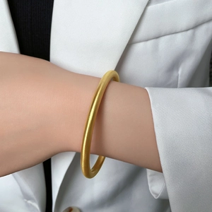 Classic matte brushed 18k gold plated titanium steel bangle shown on a wrist