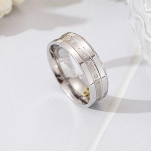 Close-up of wide silver titanium steel ring featuring THE CHANGE engraving