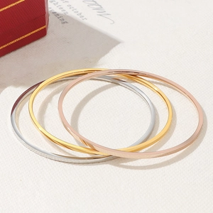 Set of three polished minimalist bangle bracelets in silver, gold, and rose gold finishes