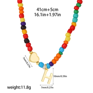 Close-up of rainbow beaded necklace with golden heart and H-letter pendant measurements