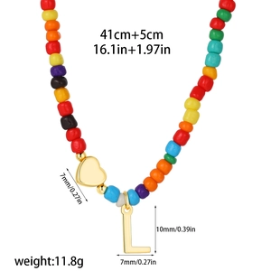 Detail view of colorful beaded necklace with gold heart and letter L charm with dimensions