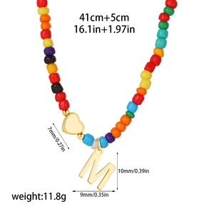 Detailed dimensions of 14k gold heart and M letter pendant on rainbow beaded necklace