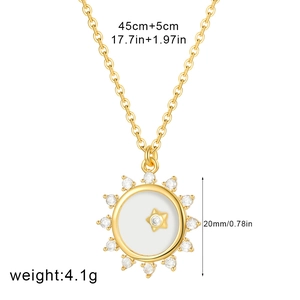 Detail view of 18K gold plated compass pendant with white shell and zircon inlay