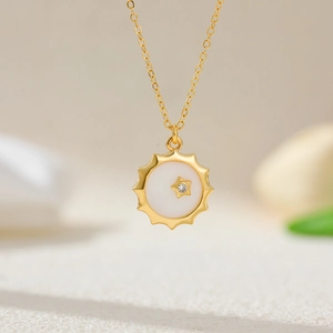 Detailed view of 18K gold plated compass pendant necklace with mother of pearl and zircon