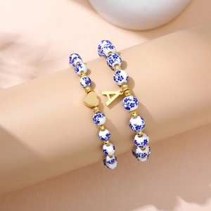 Blue floral ceramic bead bracelet set with golden heart and letter A charms