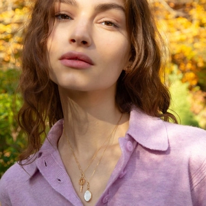 18K gold plated compass necklace with pearl shell and matching earrings set on a model