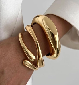Close-up of a 3-piece 14K gold-plated chunky cuff and spiral coil bracelet set