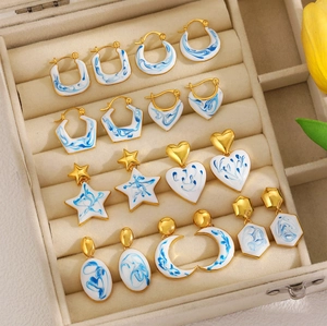 Collection of 18K gold-plated enamel earrings with blue floral patterns in various shapes