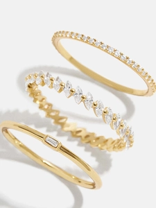 Close-up of three 18K gold-plated rings featuring baguette and marquise cut cubic zirconia