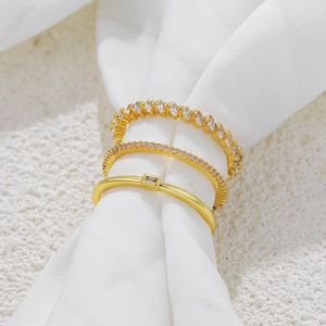 Set of three 18K gold minimalist stacking rings featuring clear zircon stone settings