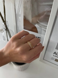 Detail view of 18K gold-plated triple-layer stacking ring with sparkling zircon stones