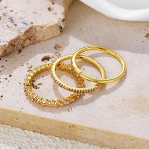 Three-piece 18K gold plated ring set with zircon pavé accents on a minimalist stone base