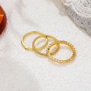 Close-up of three 18K gold-plated rings with zircon pavé and marquise stones