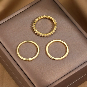 Detailed view of 18K gold plated minimalist stacking ring set on brown jewelry box