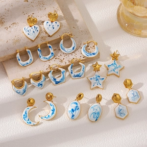 Vintage 18K gold earrings with blue floral enamel patterns in a luxurious set