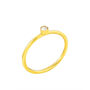 Detailed close-up of a minimalist gold zircon ring with a secure bezel setting