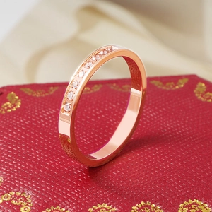 Detailed macro view of 18k rose gold plated ring with CNC set sparkling diamonds
