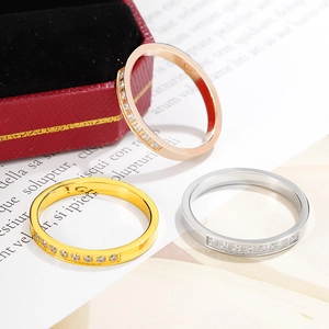 Detailed macro view of three half-eternity bands in rose gold, gold, and silver finishes