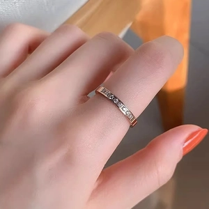 Minimalist 18k rose gold plated titanium ring with CNC set stones on female finger