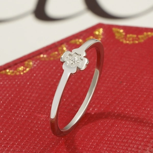 Makroaufnahme eines funkelnden Kleeblattrings mit Diamantfassung auf einer roten Schmuckbox