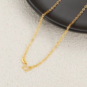 Macro detail of 24K gold plated chain with ornate texture and classic W-hook clasp