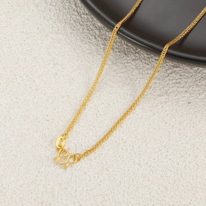 Detail of 24K gold plated titanium wheat chain with secure S-hook clasp and metal tag