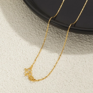 Detailed macro view of 24K gold plated twist chain necklace with secure M-clasp closure