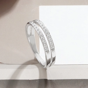 Close-up of double-row zircon inlay on polished silver titanium steel ring for women