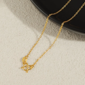 Macro shot of gold plated O-link chain with a secure M-clasp and 750 hallmark tag