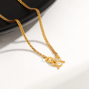 Macro detail of a 24K gold-plated titanium steel Chopin chain with a secure M-shaped clasp