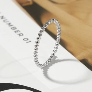 Macro view of minimalist beaded silver steel ring featuring polished metallic spheres
