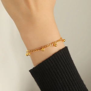 Elegant gold beaded tassel bracelet in minimalist titanium steel for a chic fashion style