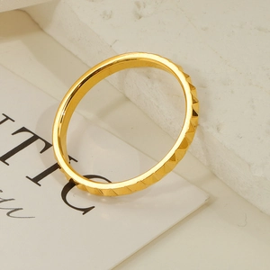 Detail shot of the faceted pyramid texture on 18K gold-plated stainless steel ring