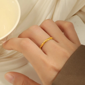 Retro 18K gold plated stainless steel ring with 3D pyramid rivets shown on hand