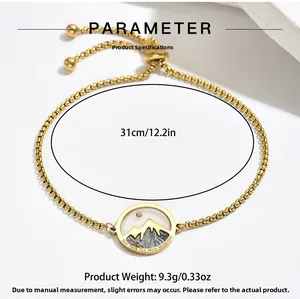 Detail of gold adjustable chain bracelet with engraved shell pendant and size labels
