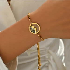 Detail of gold box chain bracelet with mountain pendant and Your Faith Can Move Mountains text