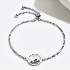 Detail of silver faith mountains engraved round pendant with adjustable slider chain